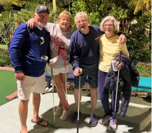 Family enjoying miniature golf and waterfront dining at Porky's Bayside Restaurant and Marina in the Florida Keys